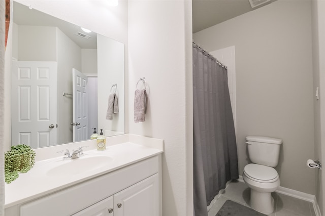 bathroom with tile patterned floors, vanity, and toilet