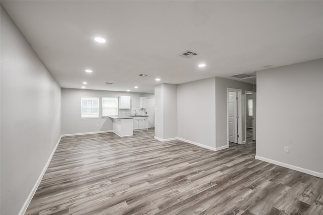 unfurnished living room featuring light hardwood / wood-style floors