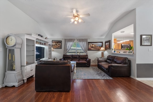 living room featuring ceiling fan, dark wood-type flooring, and lofted ceiling