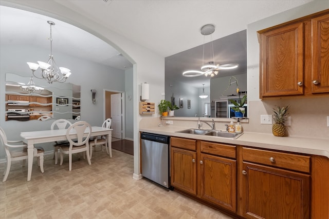 kitchen with light tile patterned floors, sink, stainless steel appliances, and an inviting chandelier