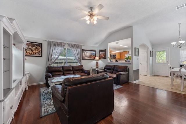 living room with lofted ceiling, ceiling fan with notable chandelier, and dark hardwood / wood-style floors