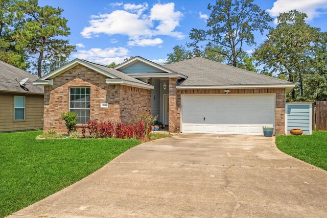 single story home featuring a garage and a front lawn