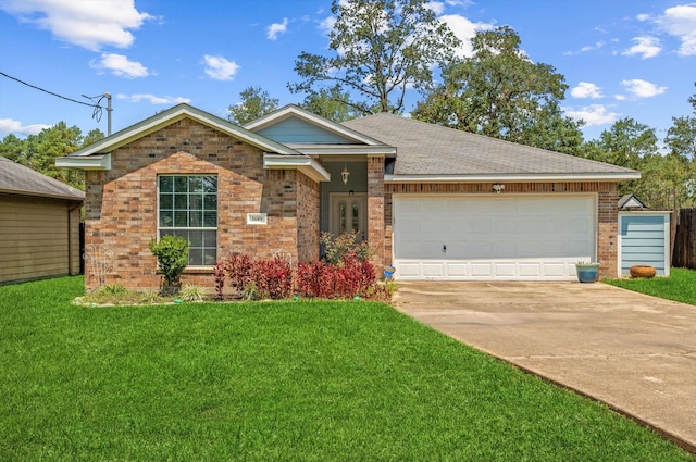 view of front of home with a garage and a front lawn