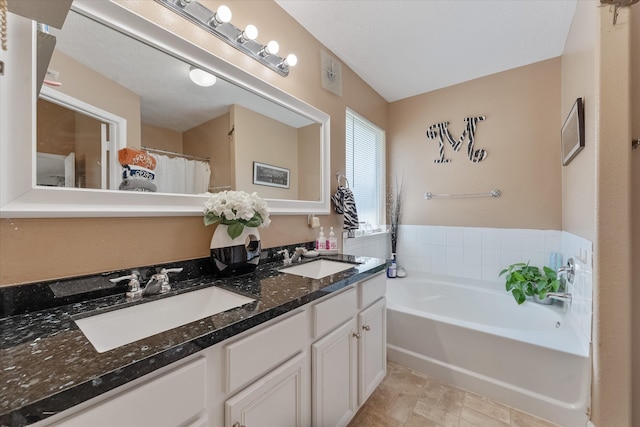 bathroom featuring a washtub, tile patterned flooring, and double sink vanity