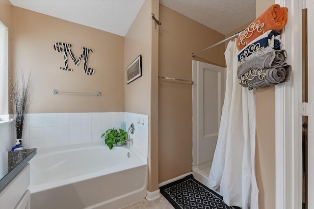 bathroom featuring tile patterned flooring, independent shower and bath, and a textured ceiling