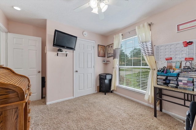 bedroom featuring ceiling fan and light carpet