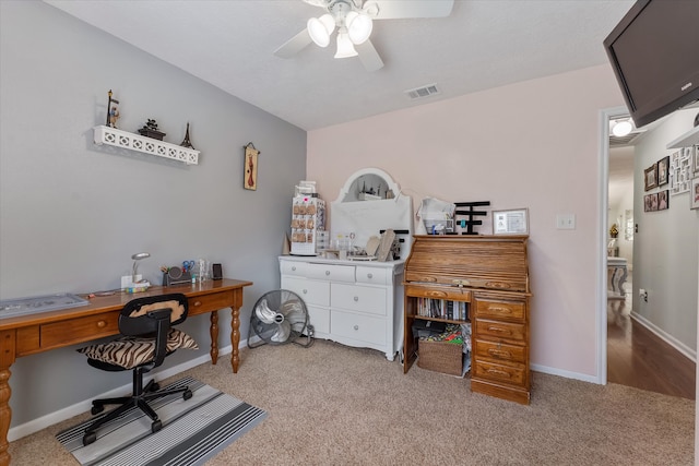 carpeted office featuring ceiling fan