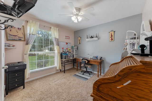 carpeted office space with ceiling fan and a wealth of natural light