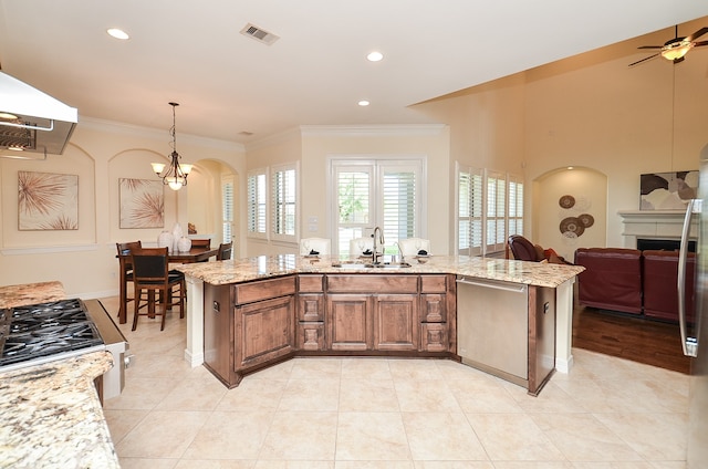 kitchen with ceiling fan with notable chandelier, light tile patterned floors, sink, and light stone countertops