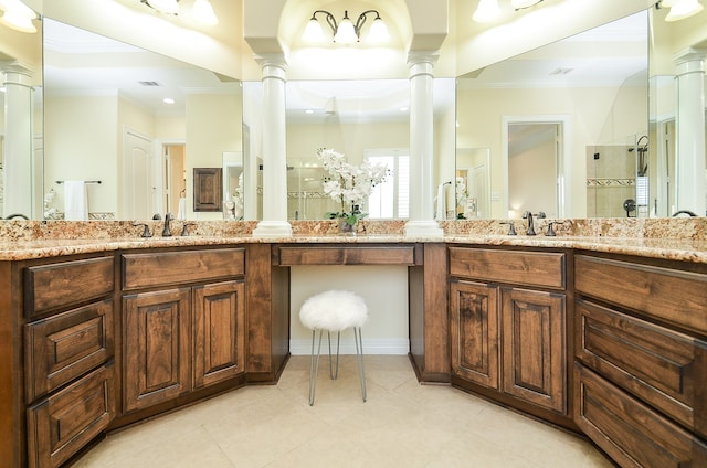 bathroom with ornate columns, double sink vanity, and tile patterned floors