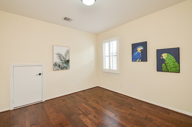 spare room with dark hardwood / wood-style floors