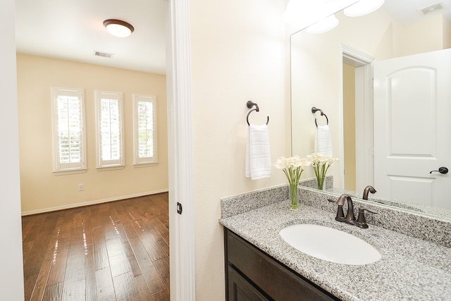 bathroom featuring hardwood / wood-style floors and vanity