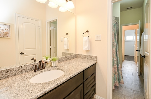 bathroom with tile patterned floors and vanity