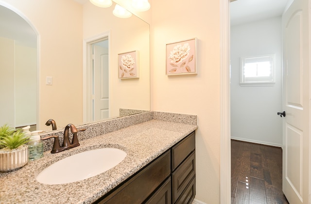 bathroom with vanity and wood-type flooring