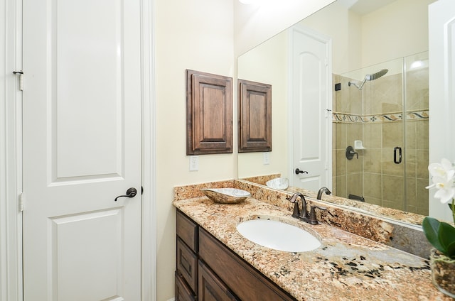 bathroom with walk in shower and vanity