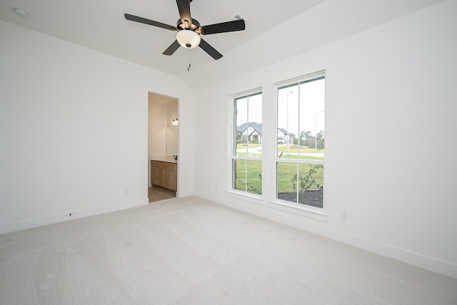 carpeted spare room with ceiling fan