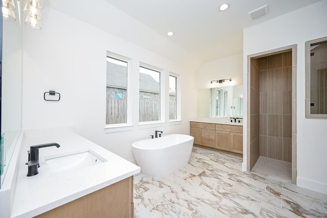 bathroom with vanity and independent shower and bath