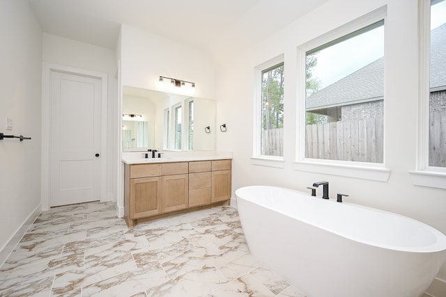 bathroom featuring a bathing tub and vanity