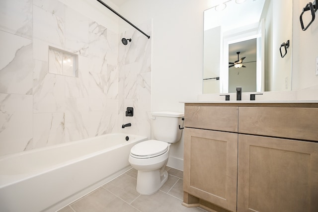 full bathroom featuring vanity, tiled shower / bath combo, ceiling fan, tile patterned flooring, and toilet