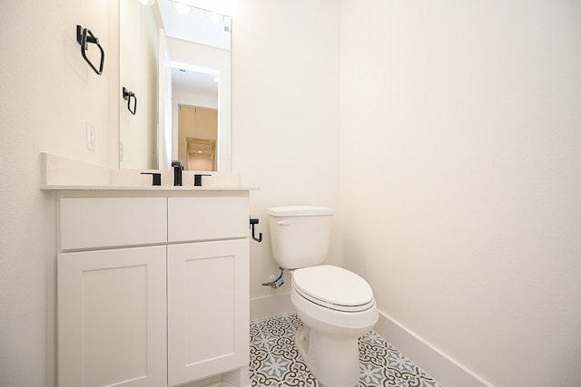 bathroom featuring tile patterned floors, vanity, and toilet