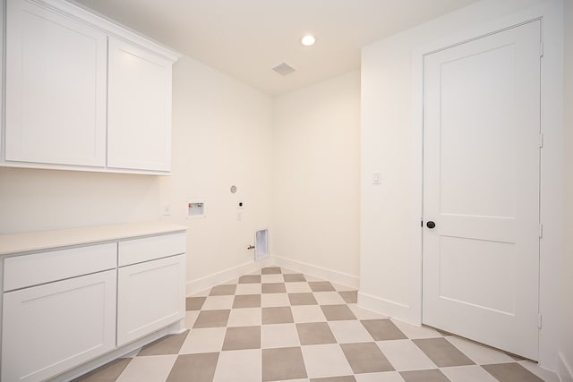 clothes washing area featuring cabinets, washer hookup, gas dryer hookup, and hookup for an electric dryer