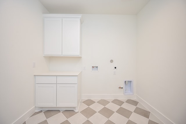 laundry room featuring hookup for an electric dryer, hookup for a washing machine, gas dryer hookup, and cabinets