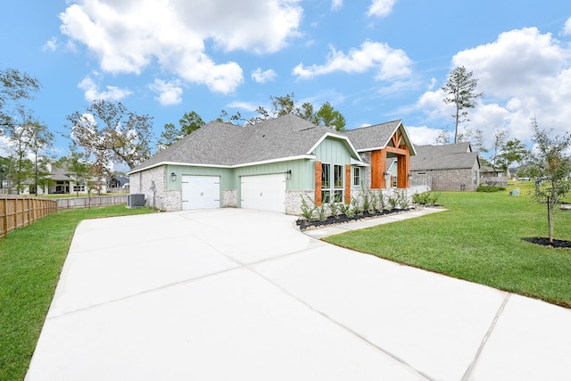 view of front of property with a garage, central air condition unit, and a front lawn