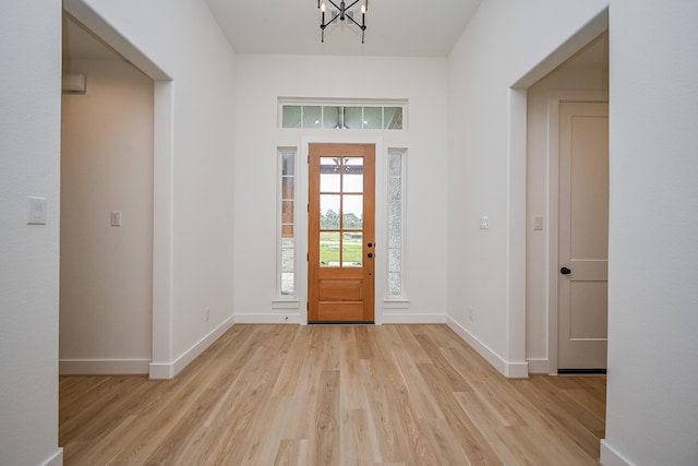 foyer featuring a chandelier and light hardwood / wood-style floors