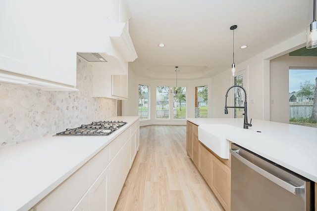 kitchen with pendant lighting, a healthy amount of sunlight, and stainless steel appliances