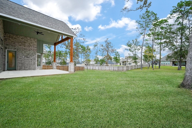 view of yard featuring ceiling fan and a patio area