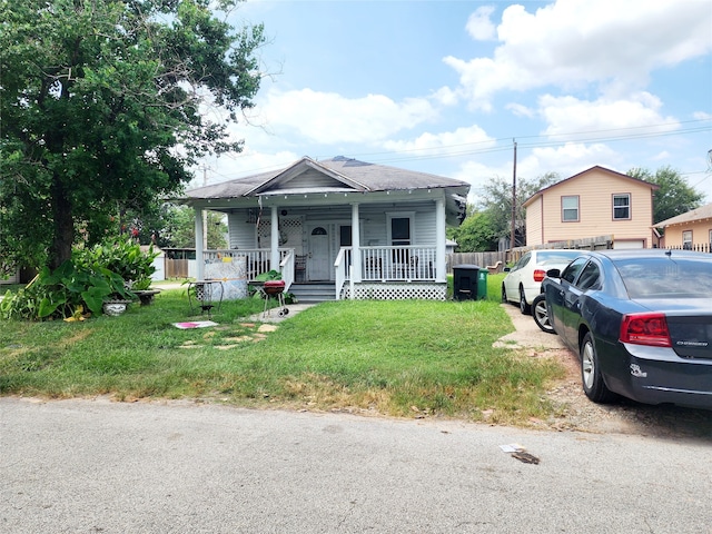 bungalow-style home featuring a porch and a front lawn