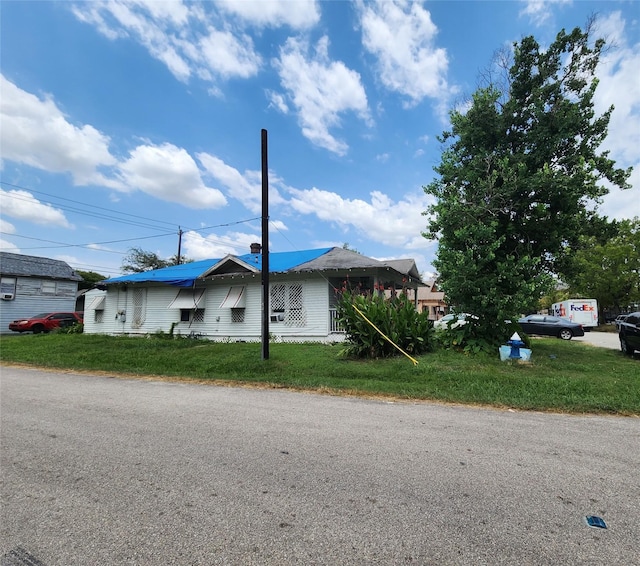view of property exterior with a yard