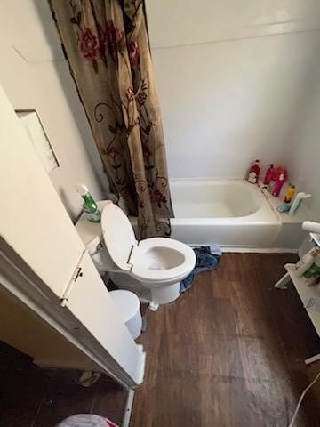 301 Vincent St, Houston, TX 77009 - bathroom with toilet, wood finished floors, and shower / bathtub combination with curtain