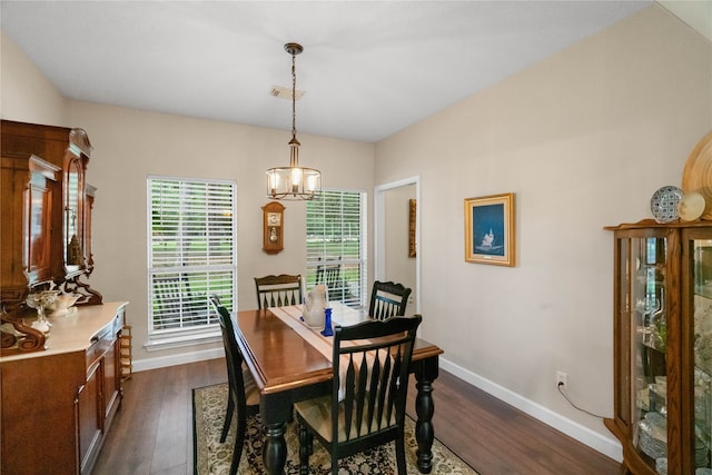 dining room with an inviting chandelier and dark hardwood / wood-style floors