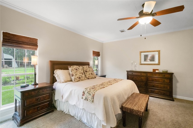 bedroom featuring ceiling fan, ornamental molding, and light carpet