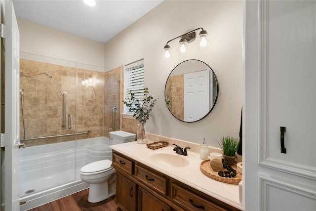 bathroom with wood-type flooring, toilet, and vanity