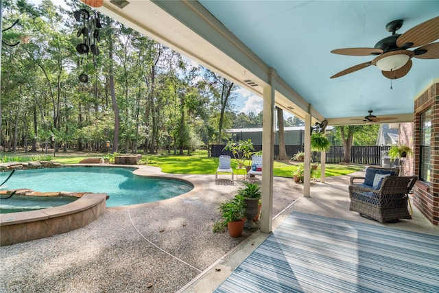 view of pool featuring ceiling fan, a lawn, and a patio area