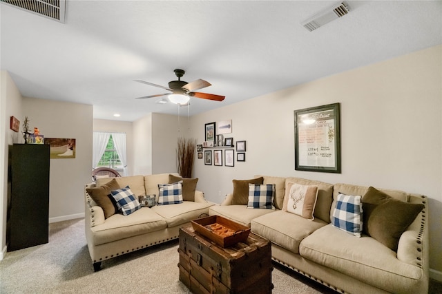 carpeted living room with ceiling fan