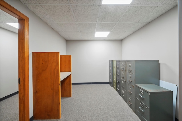 interior space featuring mail area, a paneled ceiling, and baseboards