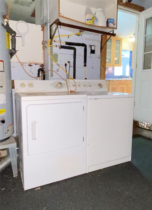 laundry area featuring washing machine and dryer and water heater