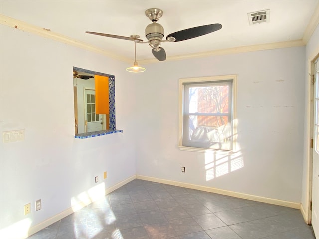 tiled empty room with ceiling fan and ornamental molding