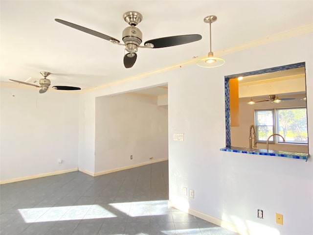 spare room with tile patterned floors, crown molding, and ceiling fan