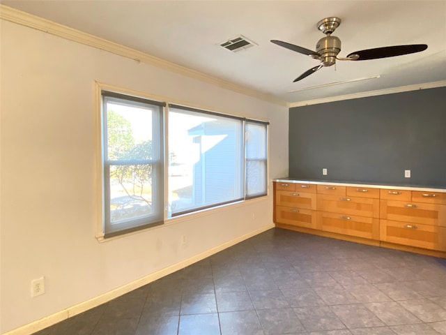 tiled spare room with ceiling fan and ornamental molding