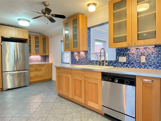 kitchen featuring backsplash, light tile patterned floors, ornamental molding, appliances with stainless steel finishes, and ceiling fan