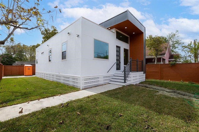 view of side of home featuring a lawn