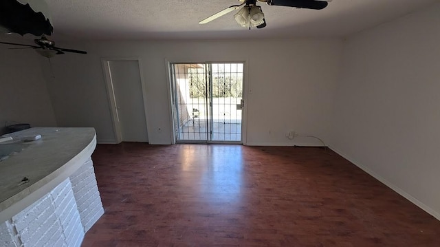 unfurnished living room featuring a textured ceiling and ceiling fan