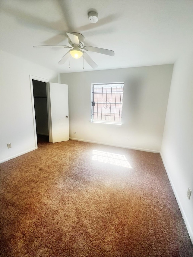 unfurnished bedroom featuring a ceiling fan, a closet, carpet flooring, and baseboards