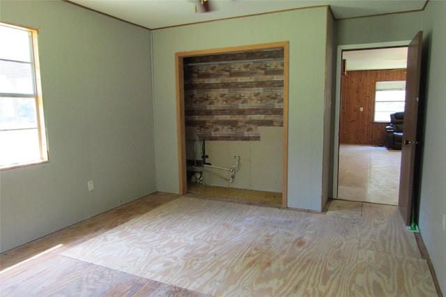 spare room with wooden walls