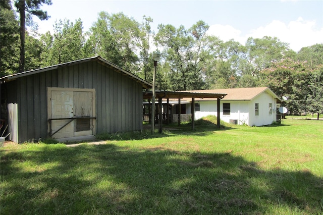 exterior space featuring a lawn and a storage shed