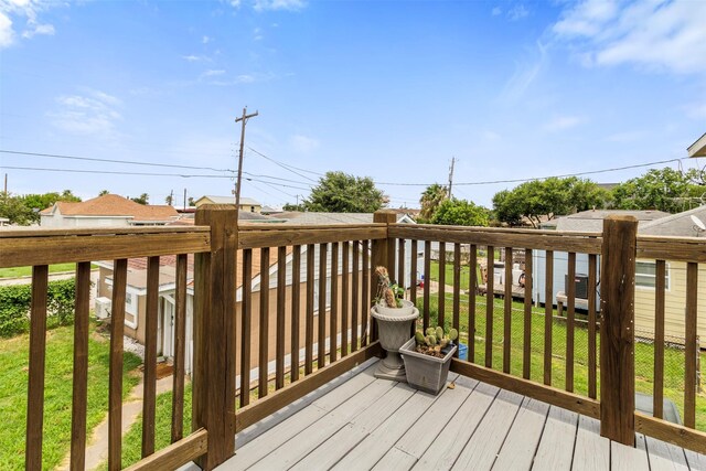 wooden deck with a lawn